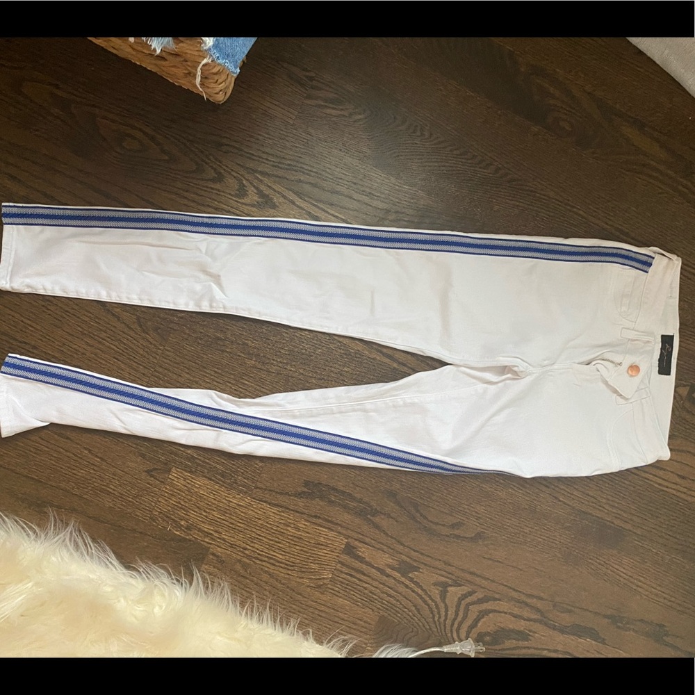 white jeans with blue embroidered stripes on side